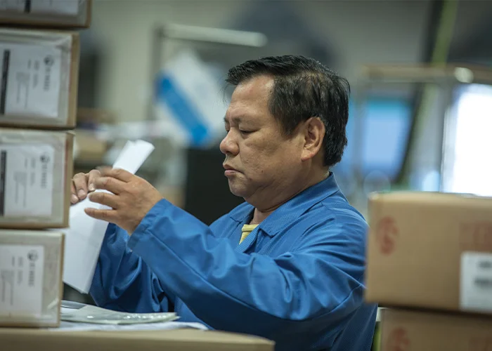 Flex employee performing kitting and late customization value-added fulfillment services